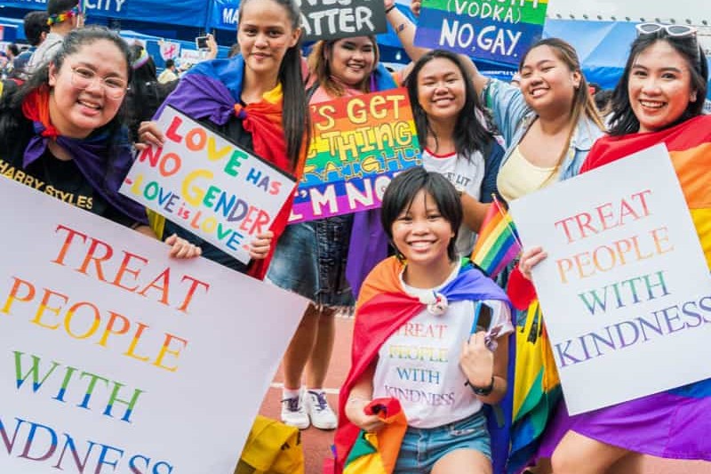 A group of people holding Pride signs